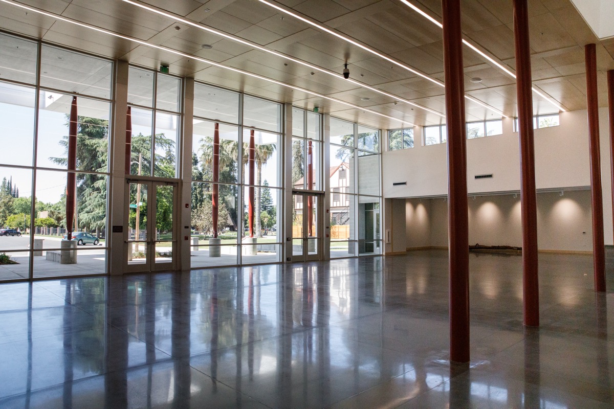 The open, light-filled Ewert Art Gallery, with floor-to-ceiling windows and red columns
