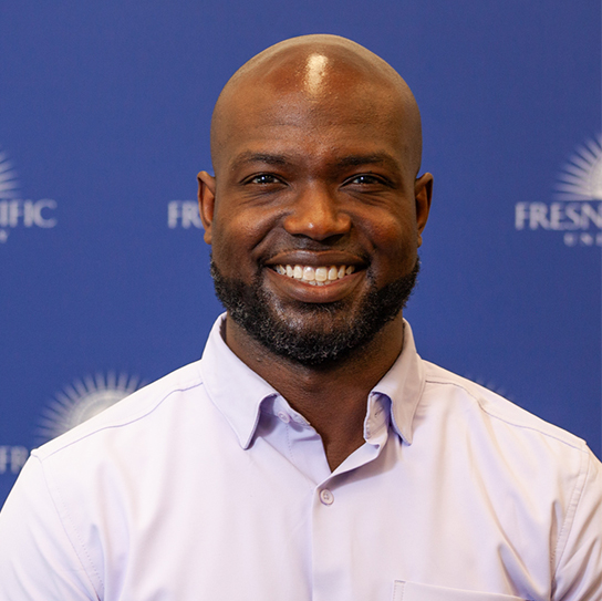 Photo of Andre Payne in front of an FPU-branded backdrop