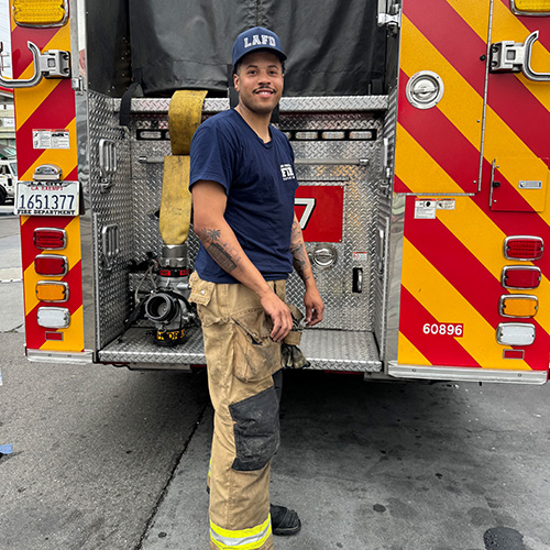 AJ Kirby standing in front of a firetruck
