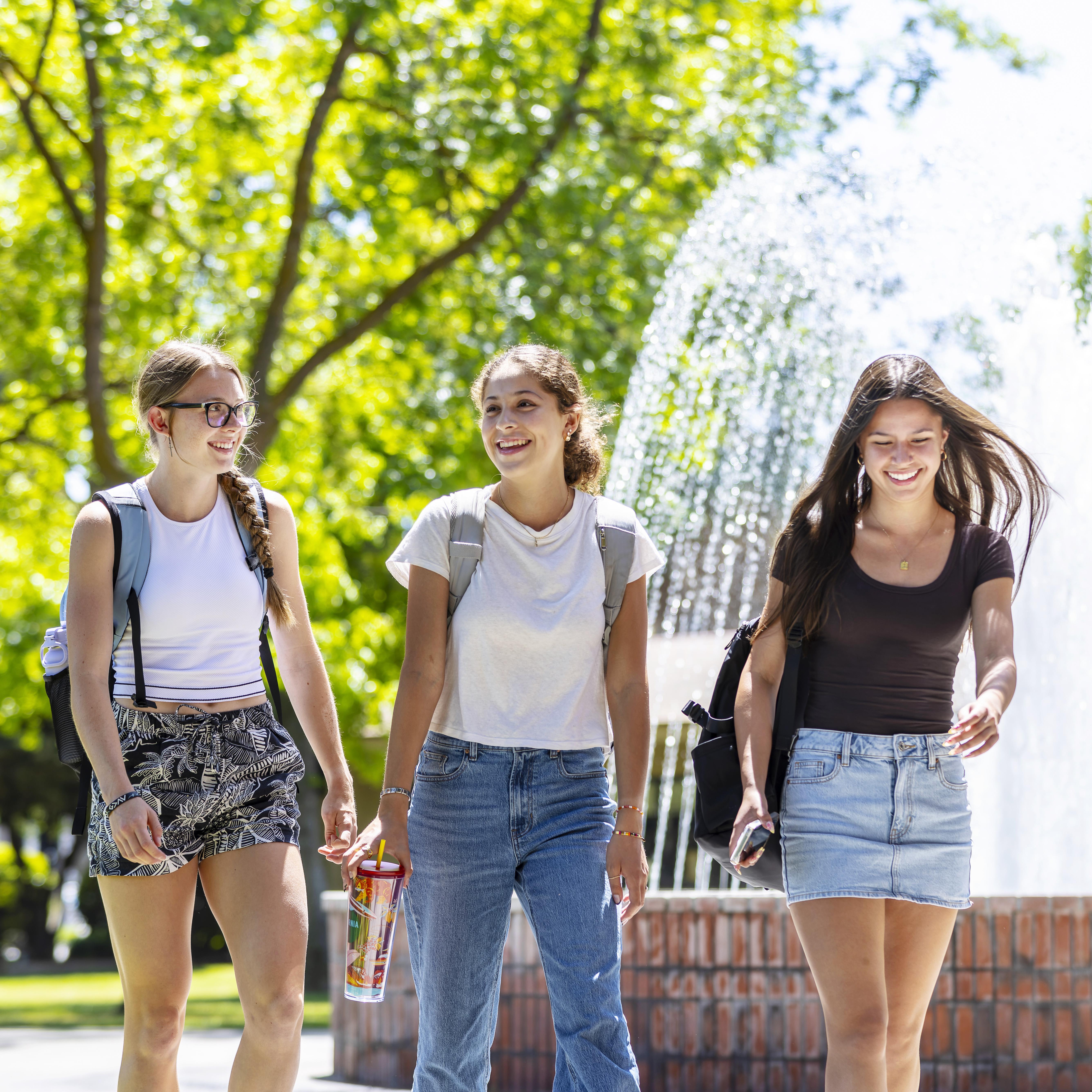 Photo of students walking by fountain