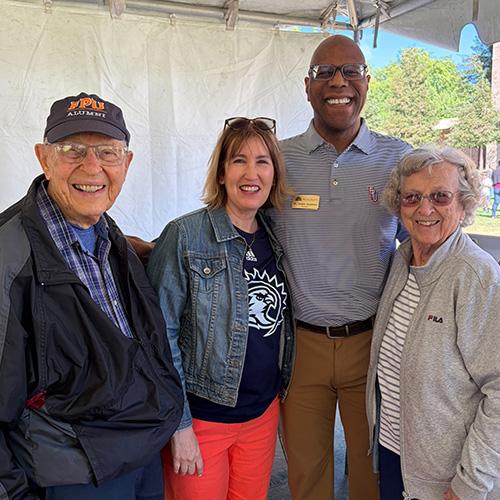 Vernon and JoElla Reimer standing with President André and Beth Stephens