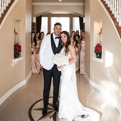 A bride and groom smiling and standing