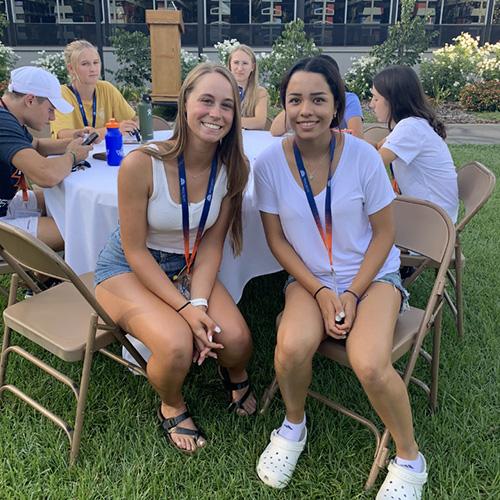 Two students sitting and smiling