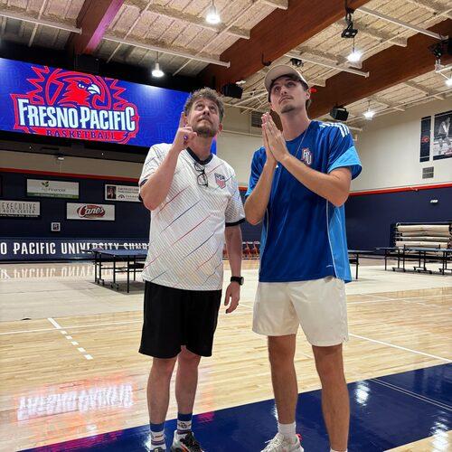 Two FPU community members look upward during an activity in the Special Events Center.