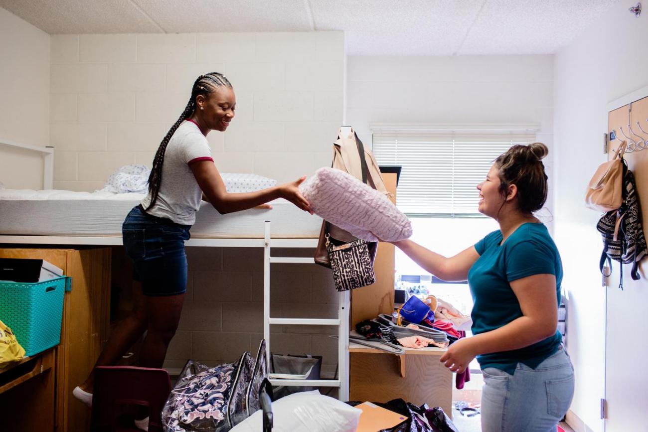 Roommates helping each other move in