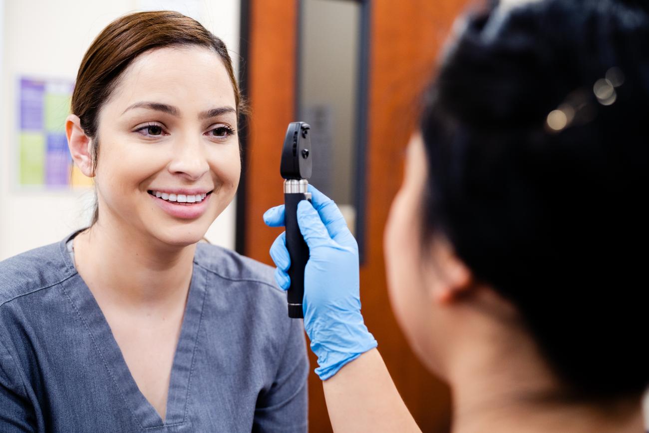 Image of a nursing student demonstrating an eye examination