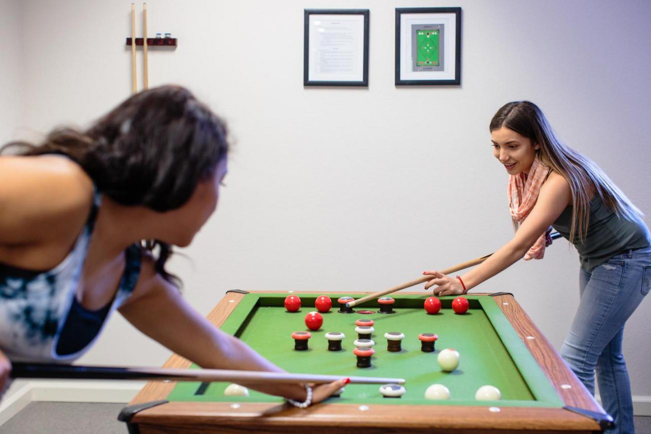 Two students playing bumper pool