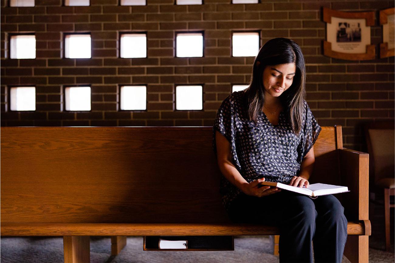 Photo of a student reading a Bible