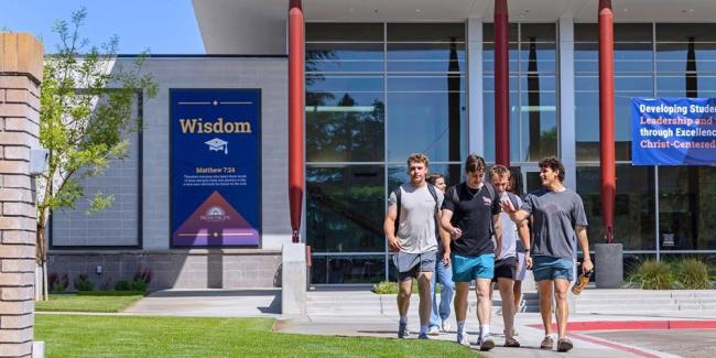A group of students walks together outside the Warkentine Culture and Arts Center at Fresno Pacific University.