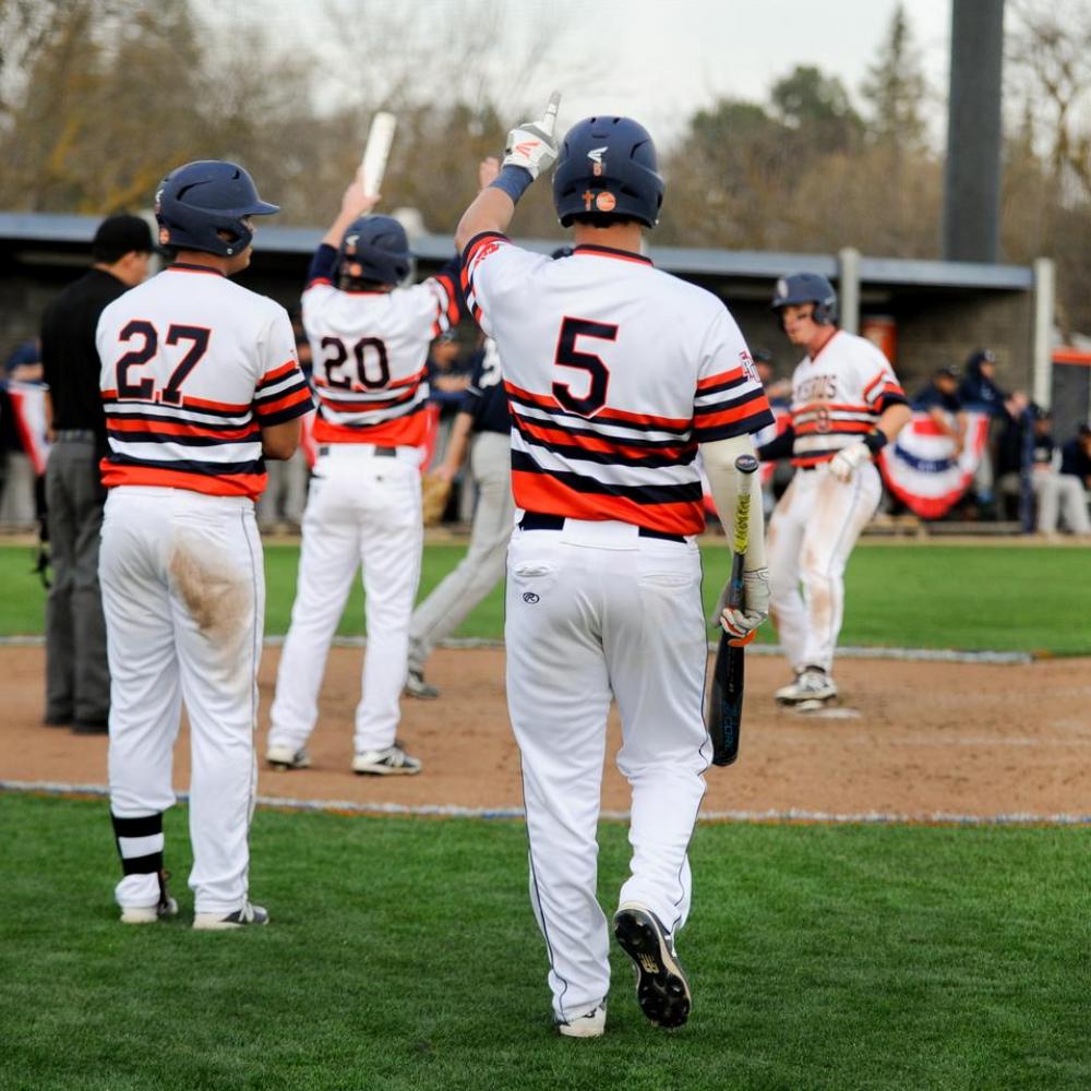 FPU Baseball players celebrating on field