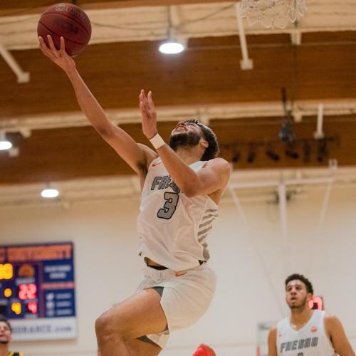 FPU basketball player going up for a lay-up