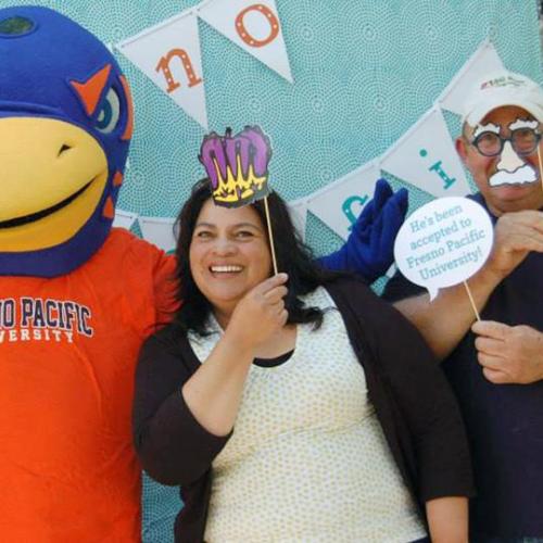 Parents and their student celebrating with Sunny the Sunbird