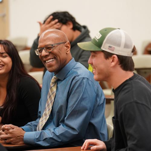 President Stephens sitting with students