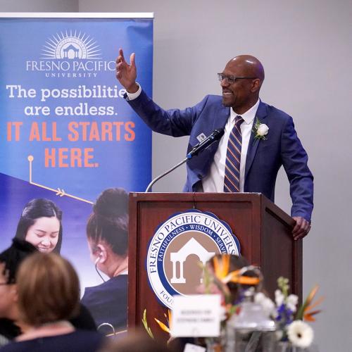 President Stephens speaking behind a podium