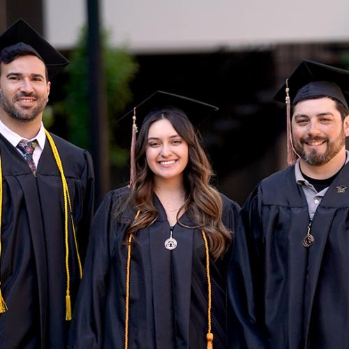 Image of three college graduates