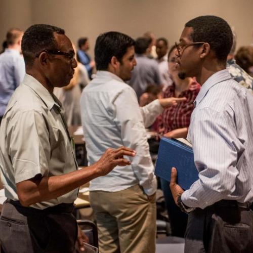 Leaders conversing and going over documents during CCT meeting