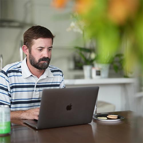 Figure sitting with a laptop