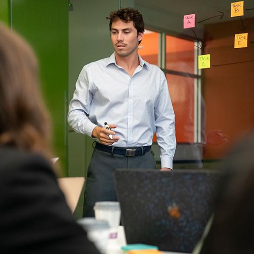 Man standing giving a business presentation