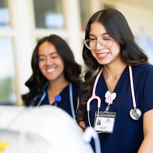 Nursing students looking at equipment