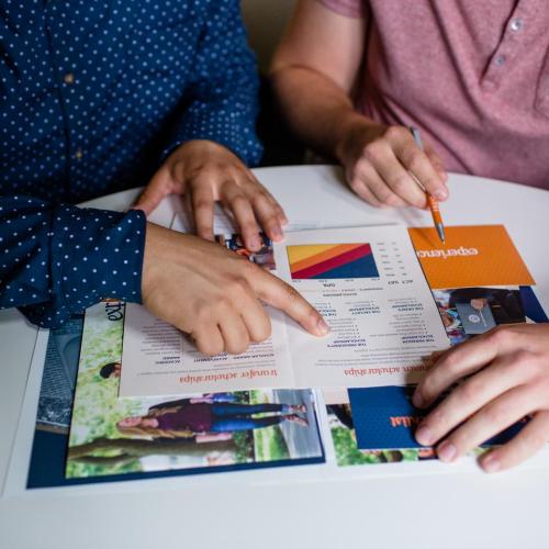 2 people looking at college brochure