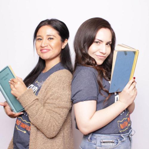 Two students in a photo booth, standing back-to-back