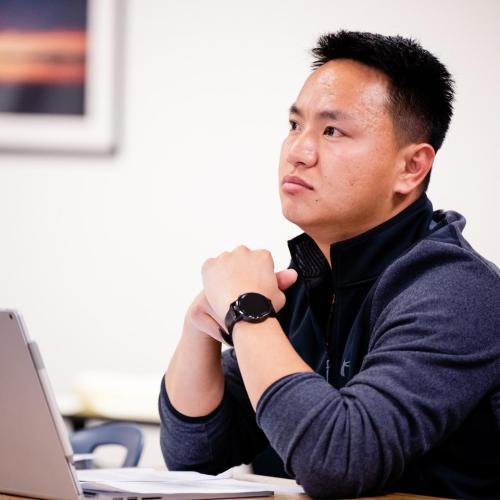 Student in a classroom listening to a lecture
