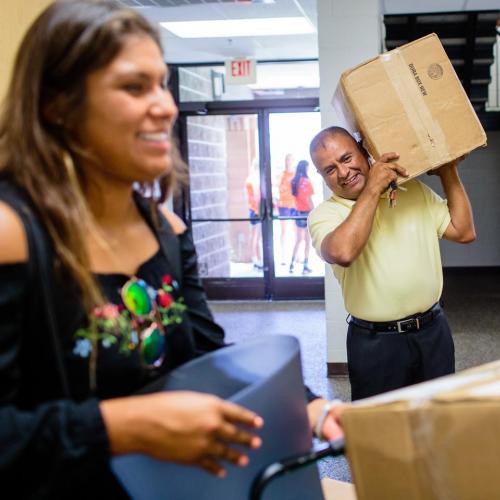 Parents helping their daughter move in to Jost Hall