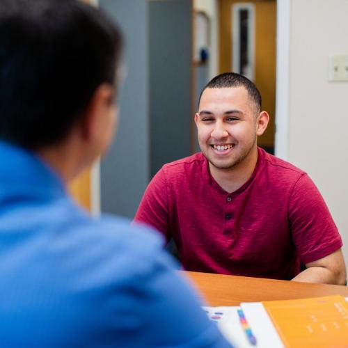 Student speaking with an advisor in an office