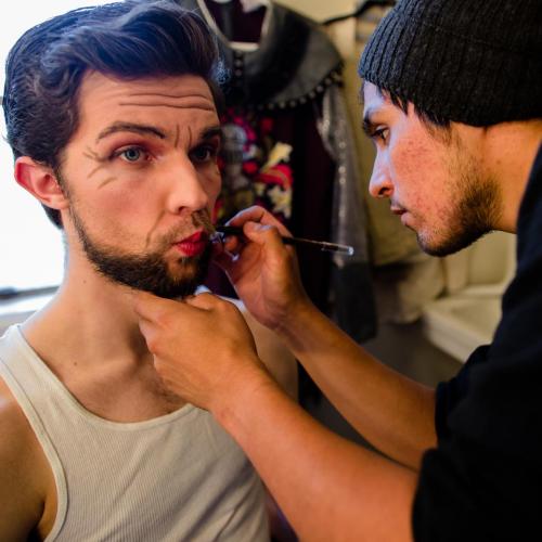 Actor getting makeup done before a performance