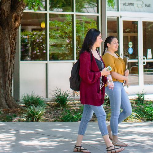 Students walking to class in front of Alumni Hall
