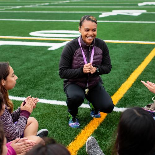A coach talking with students
