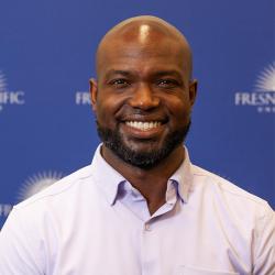 Photo of Andre Payne in front of an FPU-branded backdrop