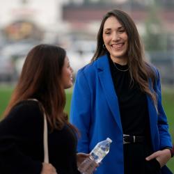 Chelsea Weber stands next to another student talking