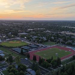 Aerial view of Fresno Pacific University’s baseball field, tennis courts and track at sunset.