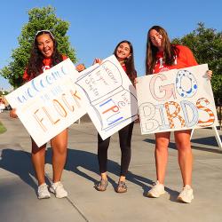 Students holding signs on FPU campus