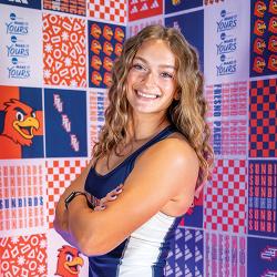 Clara Wagner, posing for a photo in front of fpu backdrop