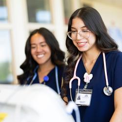 Nursing students looking at equipment