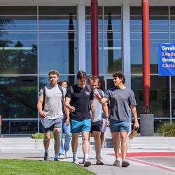 A group of students walks together outside the Warkentine Culture and Arts Center at Fresno Pacific University.
