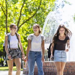 Photo of students walking by fountain