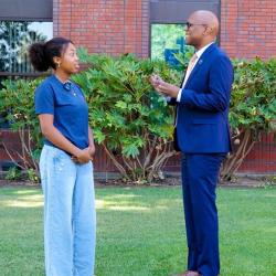 President Andre Stephens talking to a student.